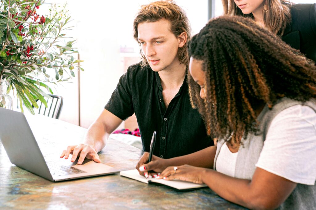 A man and a woman attending a live training session with a proven expert, learning the strategies of affiliate marketing