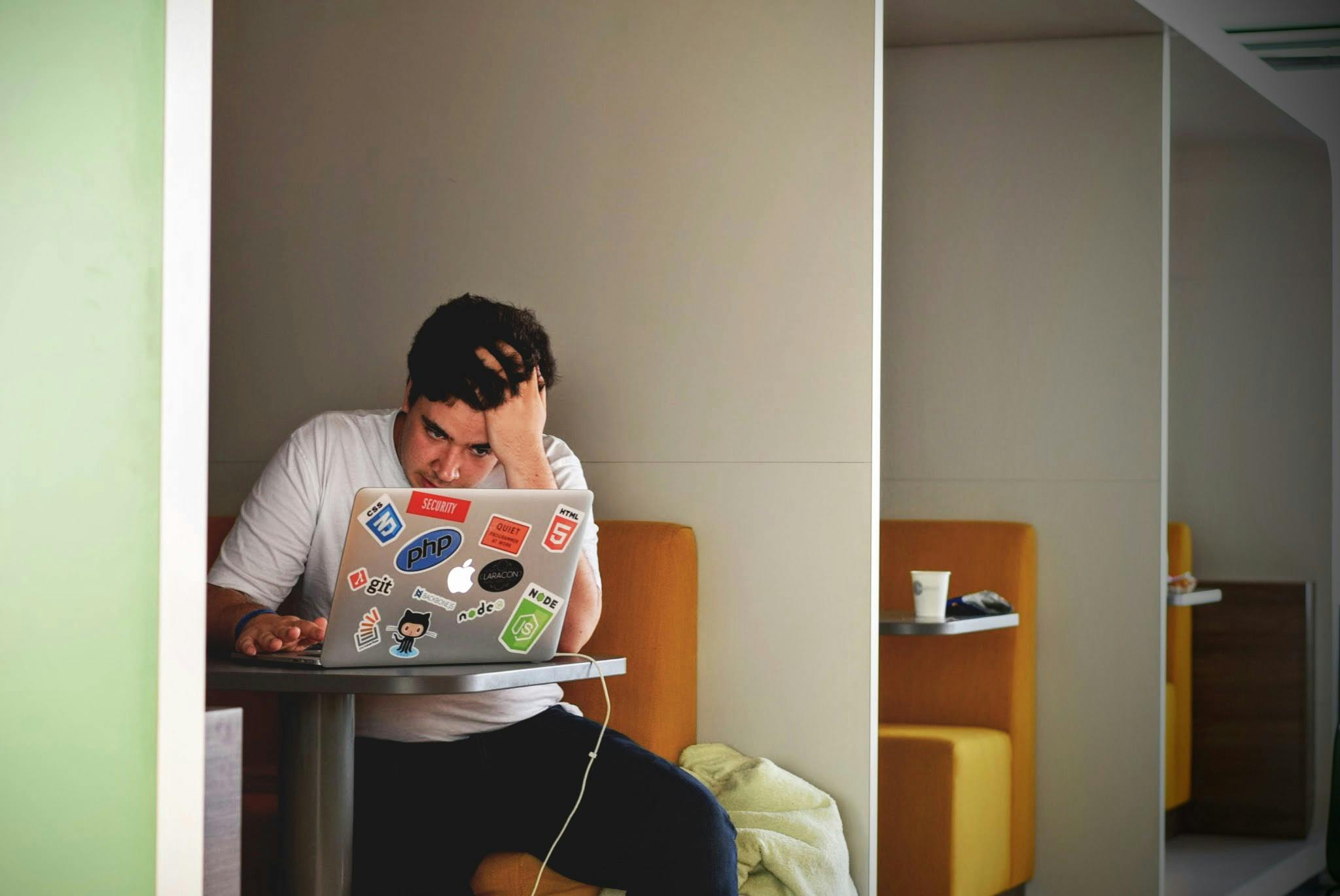 Frustrated affiliate marketer looking at a laptop, struggling to make online income
